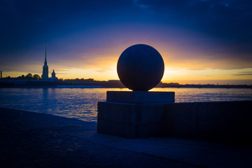 Spit of Vasilyevsky Island and Neva River at dawn with granite ball in front of sunrise, Saint Petersburg, Russia