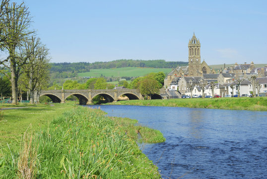 stone bridge over river Tweed and church tower at Peebles