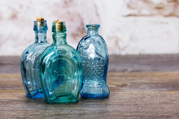 Coloured glass bottles on a rustic background
