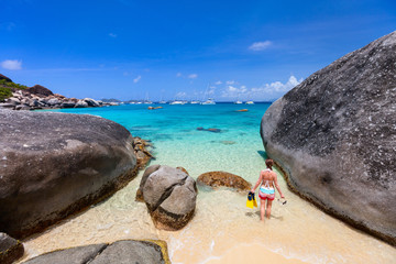 Woman with snorkeling equipment at tropical beach