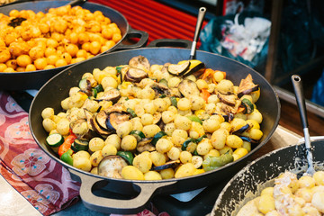 Of grilled vegetables. Vegetarian food. The outdoors and cooking on the fire. The street food. Prepared food on the market and special trading food stalls. The sale and purchase of food.