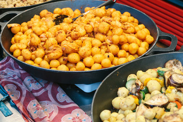 Of grilled vegetables. Vegetarian food. The outdoors and cooking on the fire. The street food. Prepared food on the market and special trading food stalls. The sale and purchase of food.