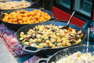 Of grilled vegetables. Vegetarian food. The outdoors and cooking on the fire. The street food. Prepared food on the market and special trading food stalls. The sale and purchase of food.