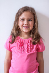 Little Russian Six-Year Girl In Pink T-Shirt On White Background.