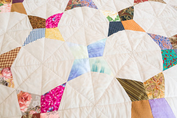 Part of color patchwork quilt as background. Handmade, art, hobby concept. Colorful Scrappy blanket. top view.