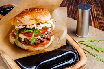 Delicious hamburger on wooden table