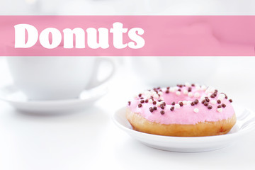 Delicious donut on saucer with cup of tea closeup