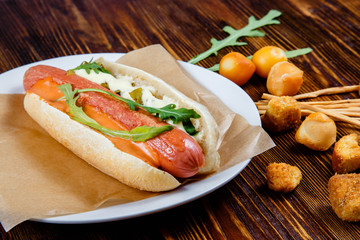 Hot dog with pickles and arugula and smoked beer snacks