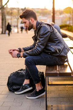 Young man sitting on a bench  