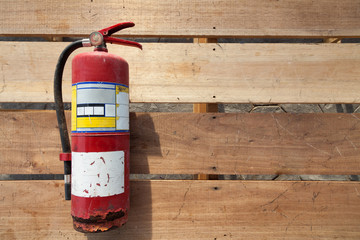 Old fire extinguisher on plank