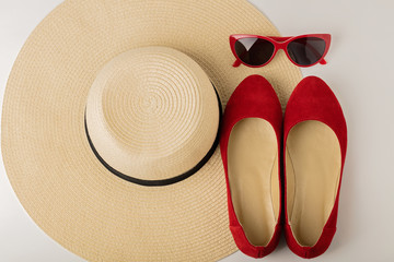 Fototapeta na wymiar Women's summer accessories - hat, sunglasses and shoes (ballet flats).