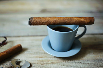 coffee, cigar on wooden table