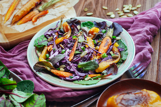 Salad with red cabbage on rustic wooden background