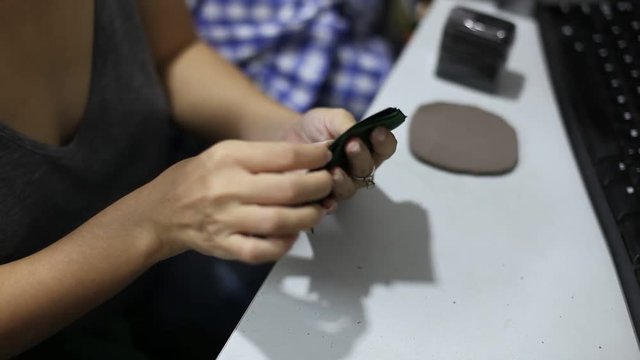 Young fashion designer woman working at home studio. Seamstress makes cutting work.
