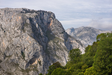 Hiking in the Los Picos de Europa up to the viewpoints, to see the mountain Naranjo de Bulnes and the summits of the neighborhood of the village Bulnes in Asturias Spain