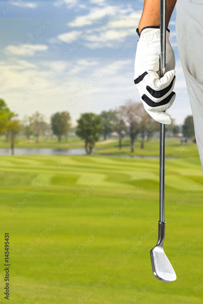 Wall mural golf player holding a golf club in golf course