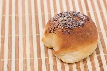 fresh bread with poppy seeds and sugar is on the table