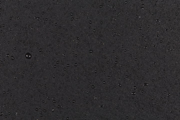 Water drops on dark stone