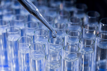 Pipette dropping fluid into test tube