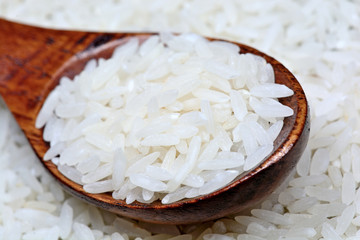 Uncooked white rice in a spoon