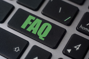 Key with text FAQ on laptop keyboard