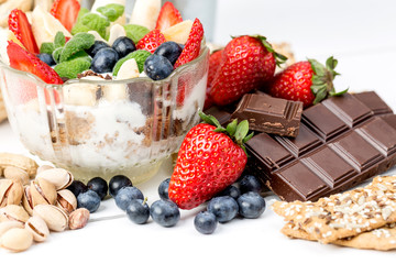 Strawberries, blueberry, nuts, chocolate and mint as the delicious healthy dessert.