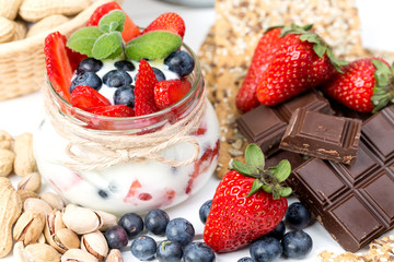 Strawberries, blueberry, nuts, chocolate and mint as the delicious healthy dessert.