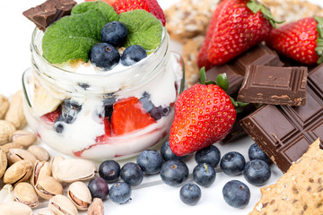 Strawberries, blueberry, nuts, chocolate and mint as the delicious healthy dessert.