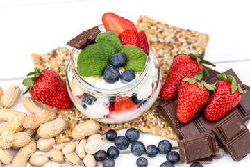 Strawberries, blueberry, nuts, chocolate and mint as the delicious healthy dessert.