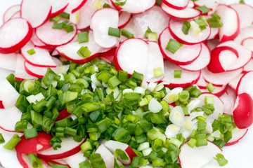 Spring salad with radishes and green onions. Fresh traditional dish of Slavic cuisine.