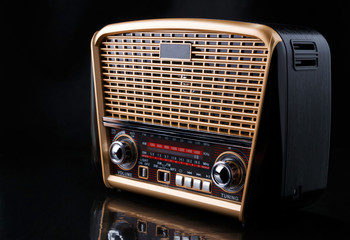 radio receiver in retro style with audio player on black background