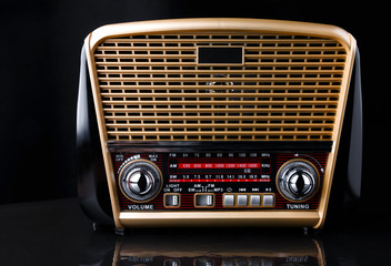 radio receiver in retro style with audio player on black background
