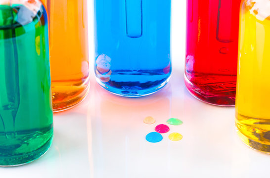 Colored drops and transparent glass bottles filled colored liquid with dropper