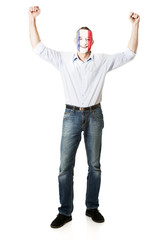 Mature man with France flag on face.