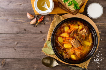 Shchi - traditional russian cabbage soup on wooden table.
