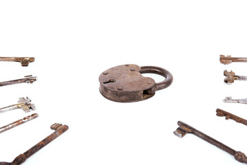 Ancient rusty padlock with collection of keys isolated on white background