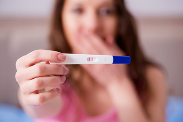Woman discovering her positive pregnancy test