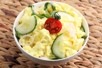 A delicious homemade creamy potato salad on a picnic table.