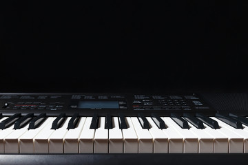 Keys of the electronic synth on a black background