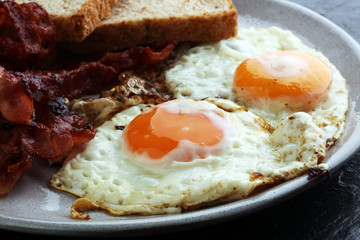 Ham and Egg. Bacon and Egg. Salted egg and sprinkled with black pepper. English breakfast.