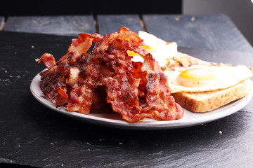 Ham and Egg. Bacon and Egg. Salted egg and sprinkled with black pepper. English breakfast.