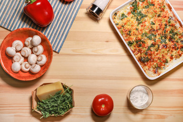Chicken vegetable cheese pie on the light wooden background