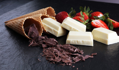 ice cream cones with white chocolate block and dark chocolate rasp and strawberries