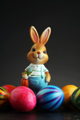 Sugar rabbit and easter eggs on stone grey