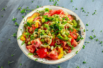 Chickpea salad with tomato, avocado, basil and olive oil