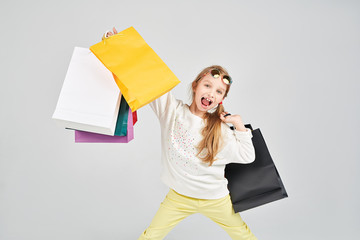 Girl is having fun with a lot of shoppers bags