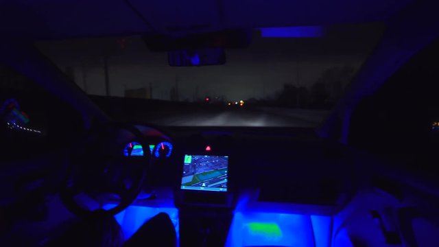 The man drive a car on the night road. inside view. wide angle, real time capture