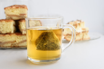 Transparent glass with green tea on white table