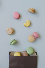 Sweet background. Delicious colorful macaroons on the light blue background, top view