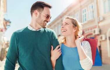 Shopping time. Beautiful couple in shopping. Consumerism, shopping, lifestyle, fashion